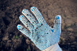 Dirty gardening glove with soil and dirt