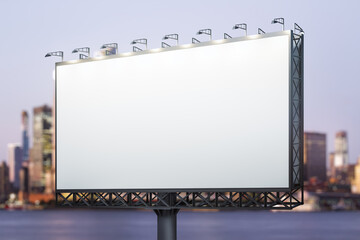 Wall Mural - Blank white horizontal billboard on skyline background at evening, perspective view. Mock up, advertising concept