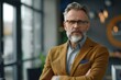 © Fotograf - A man with a beard and glasses standing confidently with his arms crossed. Suitable for business or leadership concepts
