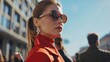 Stylish woman wearing red coat and sunglasses, perfect for fashion blogs or magazines