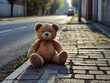 © jiraporn - Teddy bear sitting on the asphalt road. The concept of loneliness and sadness.