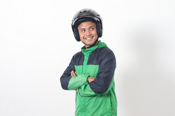 Wall Mural - Portrait of Asian online taxi driver wearing green jacket and helmet, standing with crossed arms. Isolated image on white background