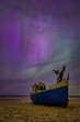 Aurora over the Baltic Sea on the beach in Katy Rybackie with fishing boat in Poland.