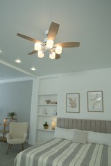 Canvas Print - Ceiling fan, furniture and houseplants in stylish bedroom