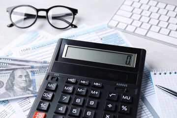 Wall Mural - Tax accounting. Calculator, documents, money, stationery and glasses on light grey table, closeup