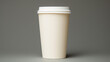 White paper cup of coffee on a grey background. Space for text or design.