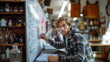 © AS Photo Family - Focused Young Man Solving Mathematics Problems on Whiteboard in a Modern Classroom Setting