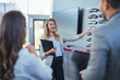© Dragana Gordic - Salesperson offering help to a couple in choosing a right color for their new car in a car salon.  Car sales business. Manager talking to couple, showing them new auto at dealership shop.