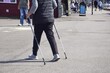 © Natalia - An adult woman with Scandinavian sticks on the street. Active lifestyle in old age