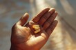 © INT888 - A hand gently holds two pills, reflecting a sense of hope and trust in medication