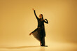 © master1305 - Artistic performance. Female dancer blending contemporary dance techniques with traditional ballet against yellow color background. Concept of art, classical dance, beauty and fashion, aesthetics