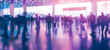 © mandu77 - Silhouettes of people walking in a busy airport terminal, reflecting on the shiny floor with cool toned lighting. Blurred image of people in trade show expo, abstract background