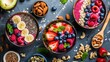 Assorted smoothie bowls with fruits, nuts, and seeds on a dark backdrop