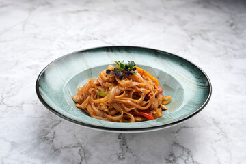 Wall Mural - Bowl of Noodles with Vegetables on a marble table background