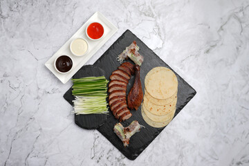 Wall Mural - Peking duck on a marble table in a restaurant. Peking duck served on tray