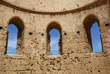 Fototapeta Lawenda - Ruins of Old Greek Orthodox Church with Windows and Blue Sky Background in Famagusta, Northern Cyprus