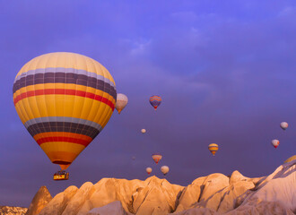 Landscape of fabulous Kapadokya. Colorful flying air balloons in sky at sunrise in Anatolia. Vacations in beautiful destination in Goreme, Turkey