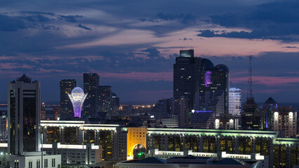 Wall Mural - Elevated night view over the city center and central business district with bayterek Timelapse, Kazakhstan, Astana