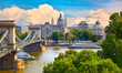 Panoramic view at Chain bridge on Danube river in Budapest city, Hungary. Urban landscape panorama with old buildings and domes of opera budapest