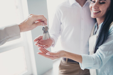 Canvas Print - Cropped photo of realtor arm give new apartment key young married couple white interior indoors