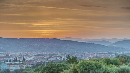 Wall Mural - Sunrise top view of Florence city timelapse with arno river bridges and historical buildings