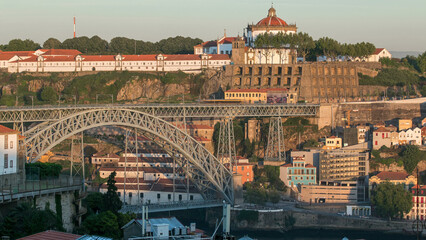 Wall Mural - Sunset time, shadow covering Douro riverside with the Dom Luiz bridge timelapse, Porto , Portugal.