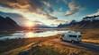 © inthasone - RV Motorhome camper van road trip. Tourists in rental car campervan by view of mountains in beautiful nature landscape on the road in Iceland at sunset. People on travel vacation adventure.