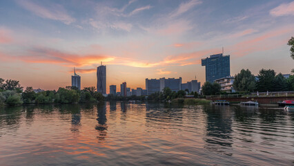 Wall Mural - Vienna international center skyscrapers with Kaiserwasser lake reflection view day to night timelapse