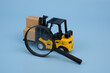 Forklift truck with shipping carton boxes under magnifying glass. Review storage and logistics service.	