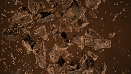 Poster - Freeze motion of flying group of raw chocolate pieces.