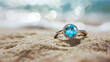 Beautiful Jewelry ring with clean aquamarine gem on sand beach background ai generative