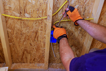 Wall Mural - An electrician installation of assembled electrical wires on interior work residential construction site