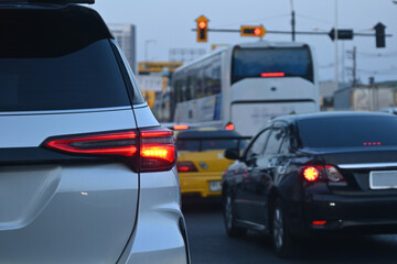 Wall Mural - red tail light of white car on road traffic jam, transportation industry