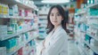 © Антон Сальников - Drugstore: Beautiful Asian Pharmacist Wearing White Coat, Standing with Crossed Arms as she Smiling Charmingly. Shelves of Medicine and Health Products.
