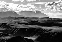 Dramatic Black And White View Of The Mountains And Valleys Of The Drakensberg Mountains With Some Of The Iconic Peaks And Cliffs Rising In The Background