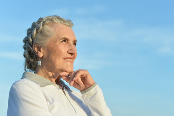 Wall Mural - Portrait of a beautiful elderly woman outdoors