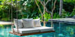 © IndigoElf - Close-up Minimal Beautiful Swing sofa on the Swimming pool water on outdoor beach in tropical hotel.