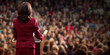 © Gary - Businesswoman in red suit standing at a podium looking at audience, room for copy