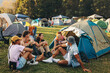 © Jacob Lund - Embracing the summer festival vibe: Young People gather at the camp, delighting in beer and laughter