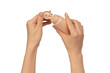 Beige cream tube in woman hands isolated on a white background. Cream swatch on woman hand.