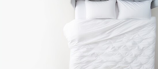 Poster - Top view of a modern bed with a soft comfortable mattress and blanket against a white background perfect for a copy space image