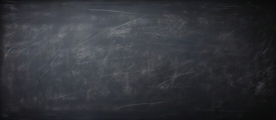 Wall Mural - Dark wall backdrop with the texture of chalk on a blackboard or chalkboard creating a school education theme and a concept of learning Copy space image