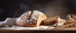 A rustic loaf of homemade sourdough bread made with rye flour freshly harvested rye grains using a rolling pin to shape the dough and adding water to hydrate the cereal grains A copy space image