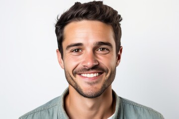 Canvas Print - Portrait of a glad man in his 30s smiling at the camera in white background