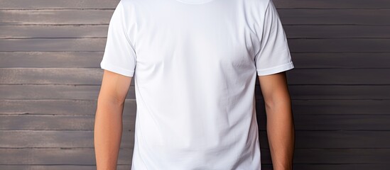 A young man wearing a blank white t shirt is featured in a close up photo providing ample copy space for design print