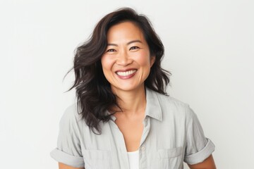 Canvas Print - Portrait of a cheerful asian woman in her 40s smiling at the camera in white background