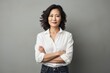 © Markus Schröder - Portrait of a content asian woman in her 40s with arms crossed over white background