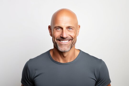 Portrait of a grinning man in his 40s smiling at the camera in front of white background