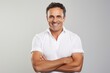 © Markus Schröder - Portrait of a grinning man in his 40s with arms crossed over white background