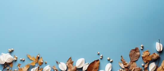 Wall Mural - copy space image of an autumn or winter composition featuring dried leaves and cotton flowers agains